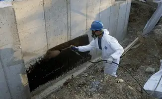 Professional waterproofing the exterior walls of the basement in Jersey City, NJ