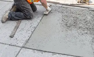 Professional repairing a concrete floor in Jersey City, NJ